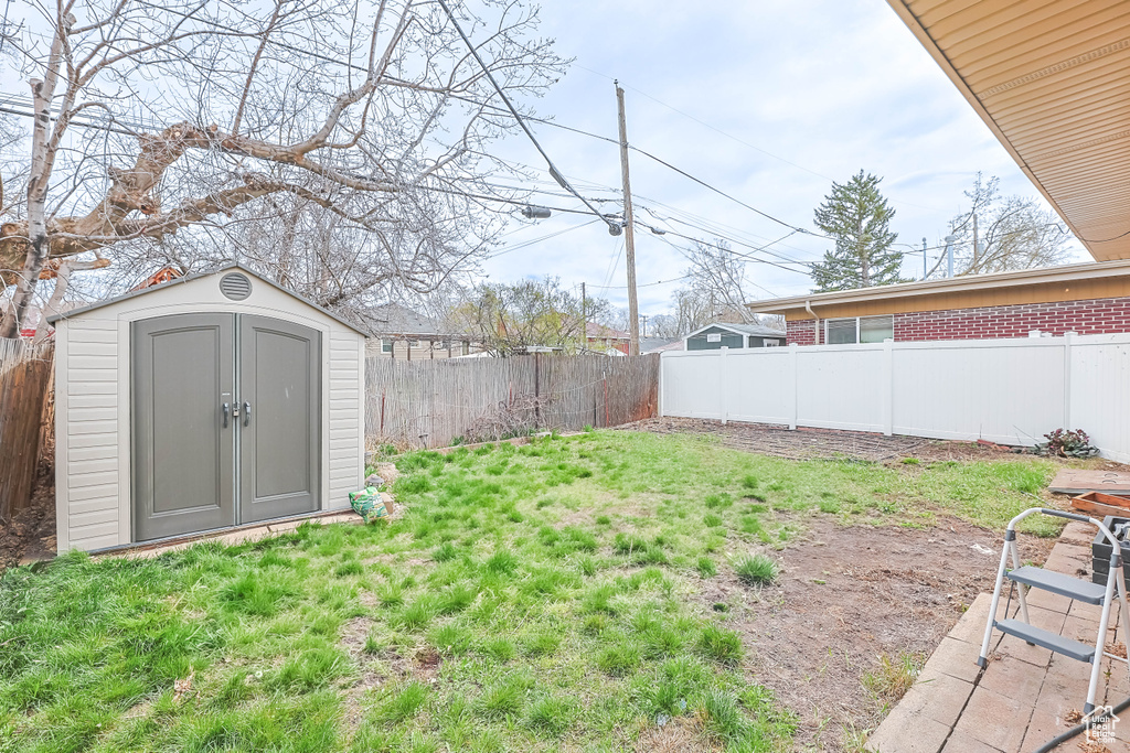 Fenced backyard with a storage shed