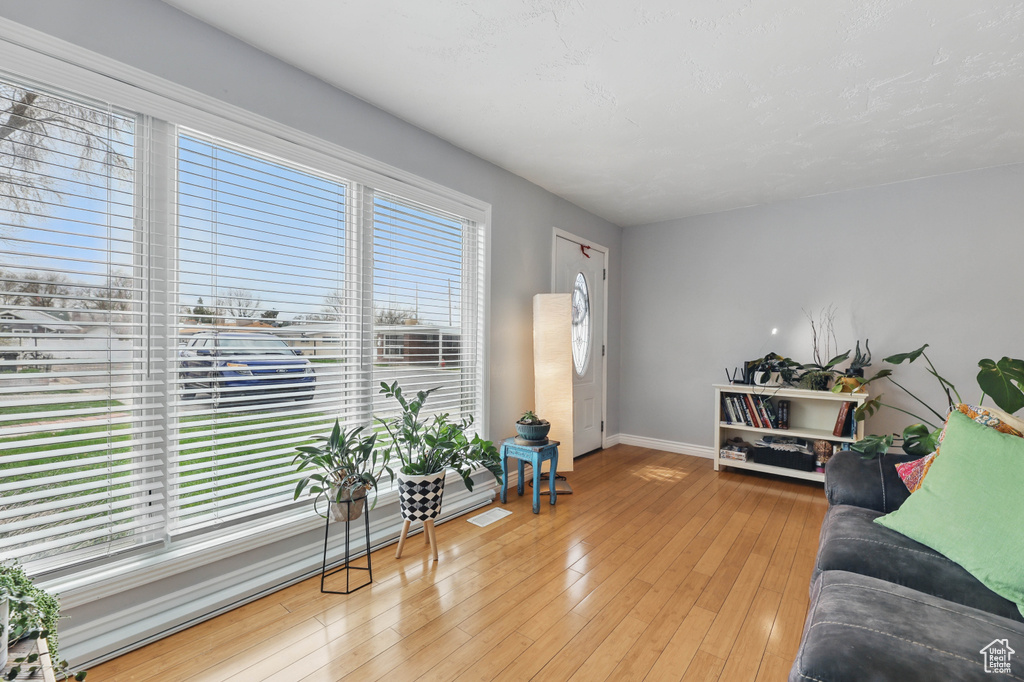 Living area with light wood-type flooring and baseboards