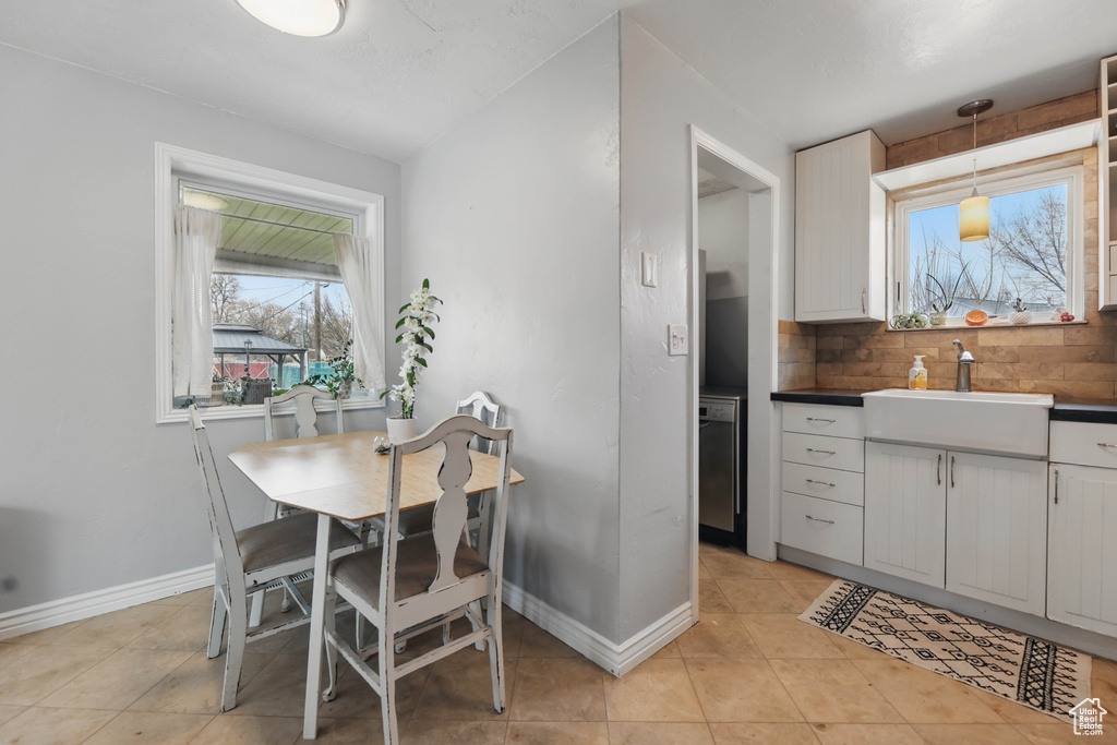 Dining room featuring baseboards and light tile patterned floors