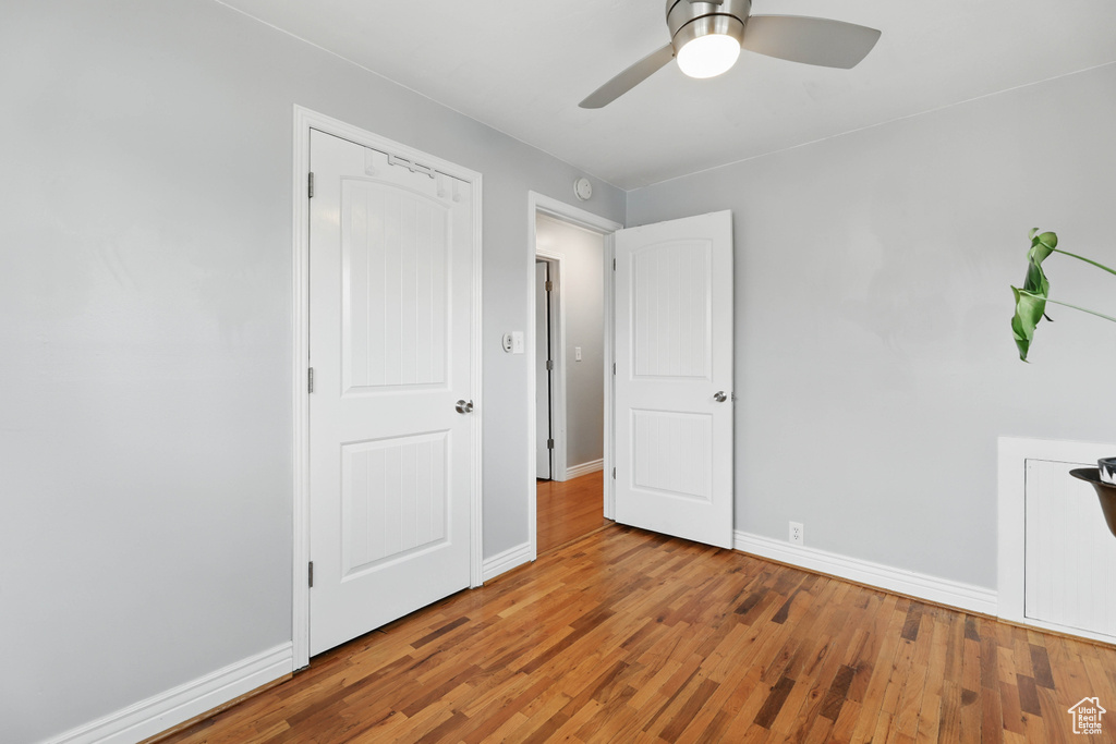 Unfurnished bedroom featuring wood finished floors and ceiling fan