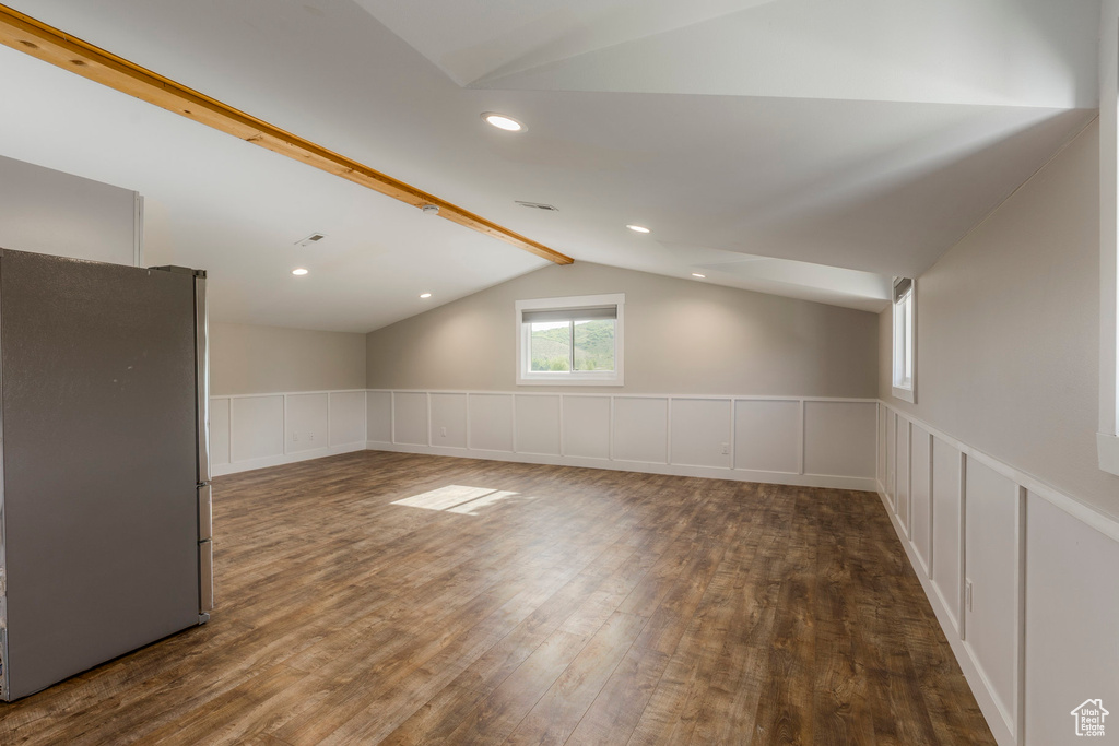 Unfurnished room featuring dark wood-style flooring, a decorative wall, a wainscoted wall, and recessed lighting