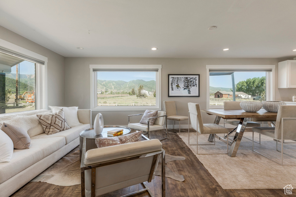 Living area with wood finished floors and recessed lighting