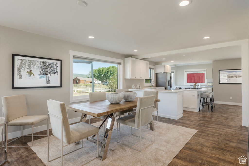 Dining space with wood finished floors and recessed lighting