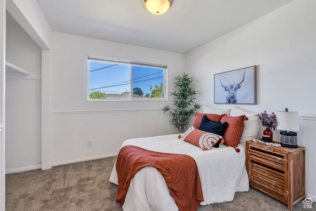 Carpeted bedroom featuring baseboards