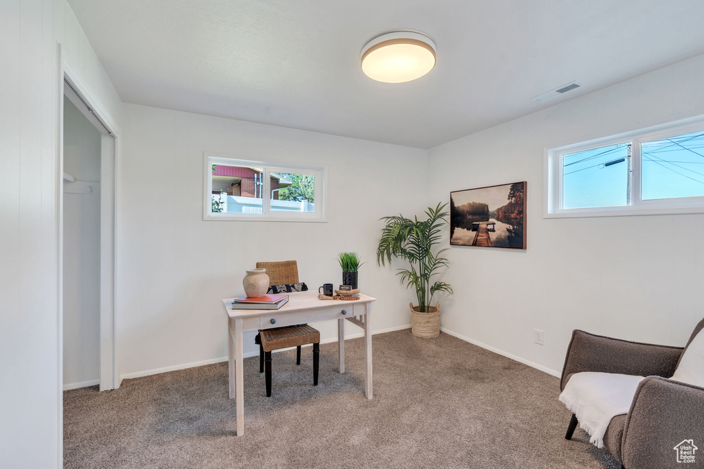 Carpeted home office featuring baseboards
