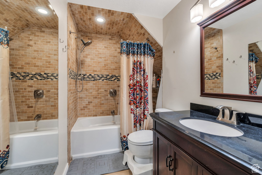 Full bathroom with shower / bath combo with shower curtain and vanity