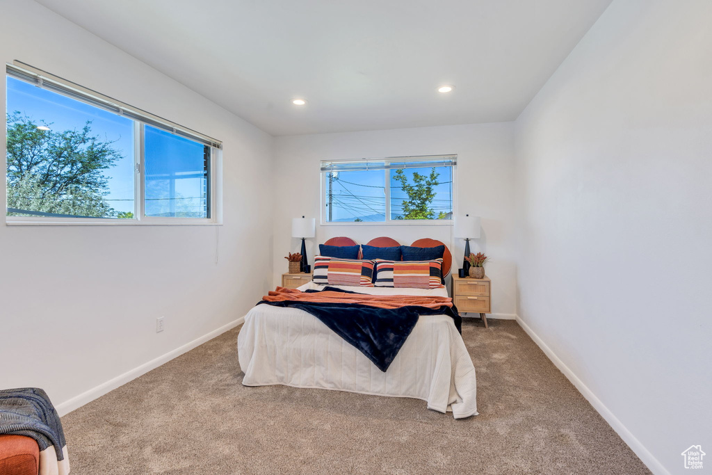 Bedroom featuring multiple windows, carpet flooring, and recessed lighting