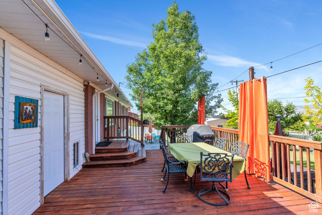Wooden deck featuring outdoor dining area