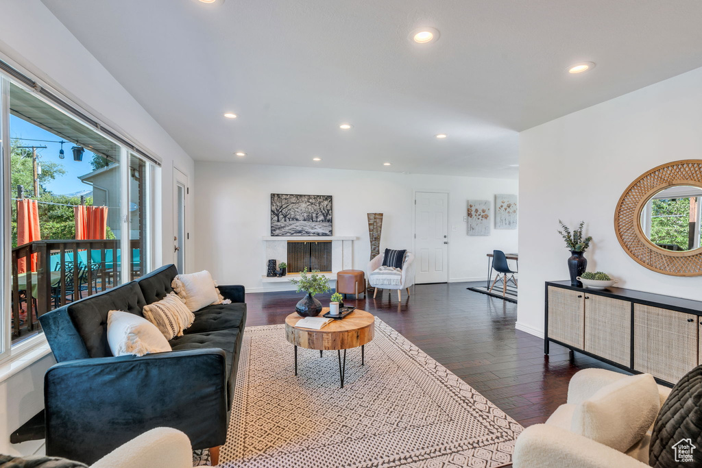Living room with recessed lighting and dark wood-style floors