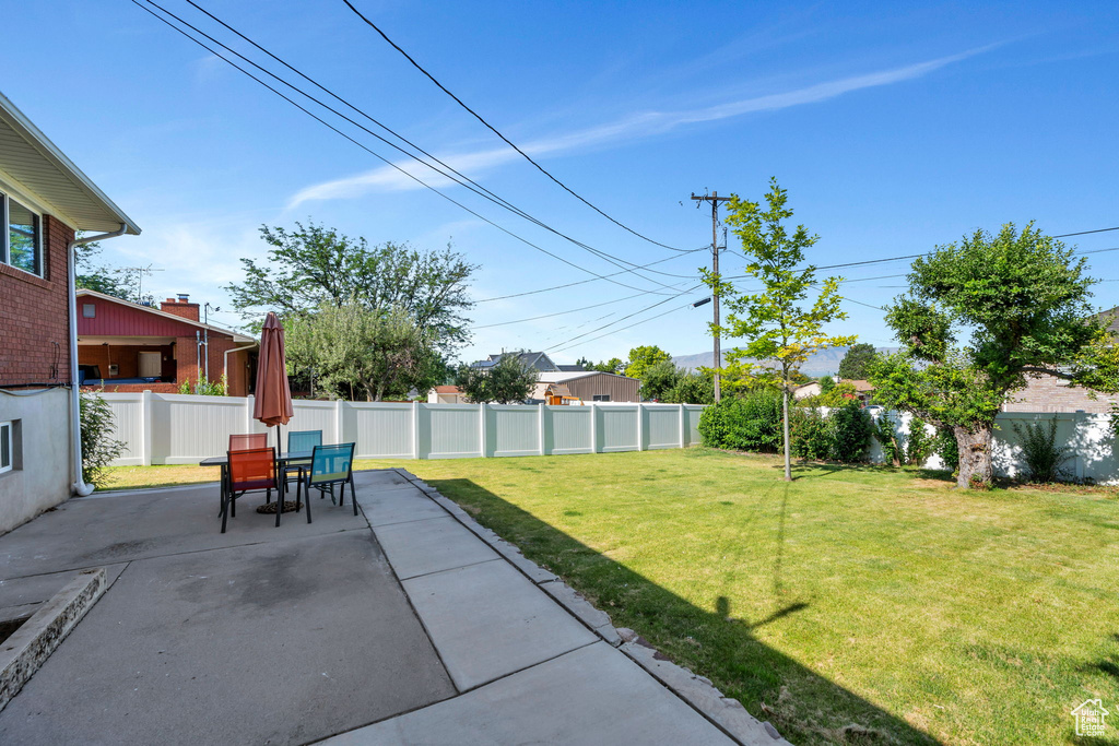 Fenced backyard with a patio and outdoor dining area