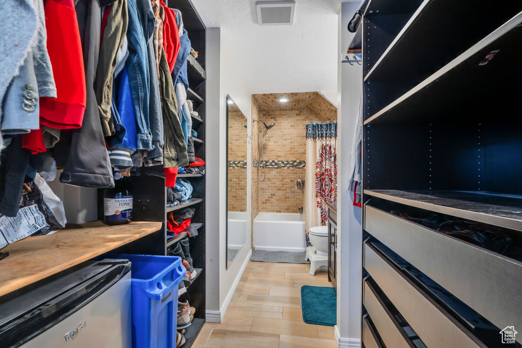 Spacious closet featuring wood finished floors