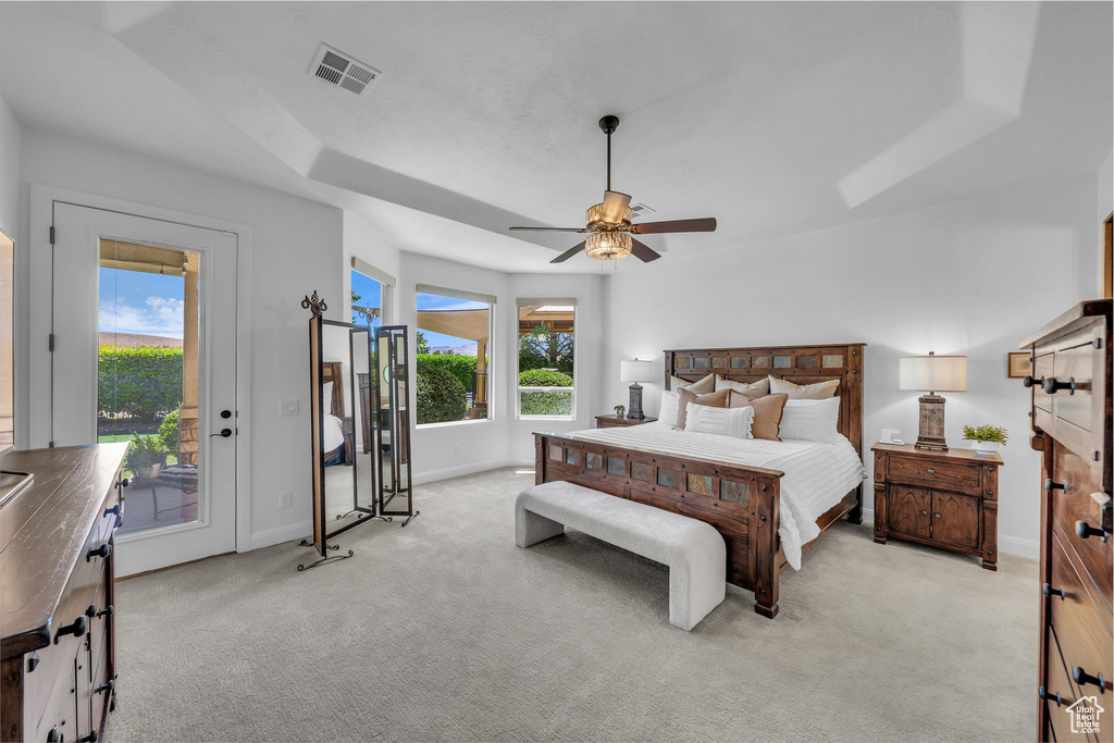 Bedroom with access to outside, light colored carpet, and a ceiling fan