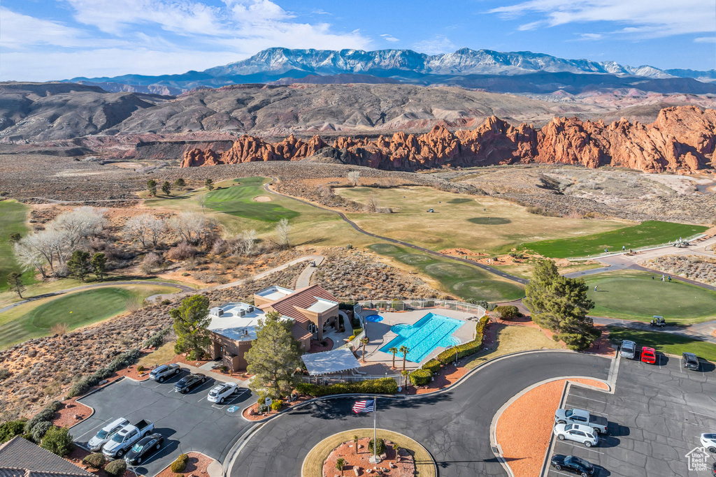 Aerial view of a mountain backdrop and a golf course