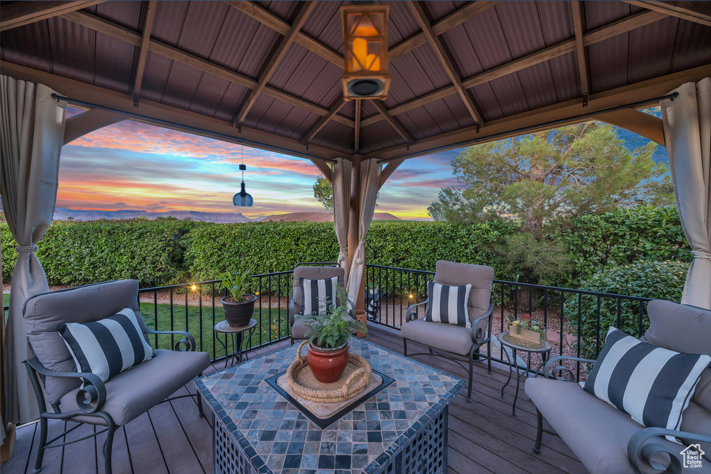 Wooden deck featuring an outdoor hangout area and a gazebo