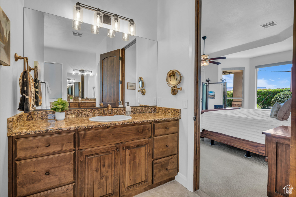 Ensuite bathroom with vanity and a ceiling fan