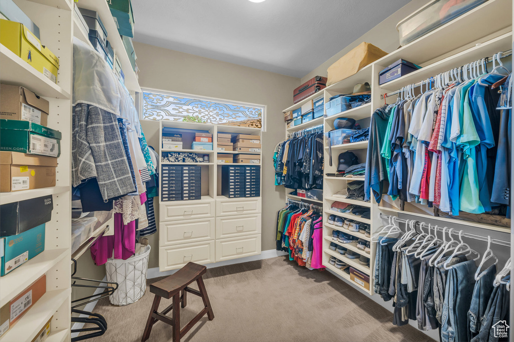 Walk in closet featuring carpet flooring