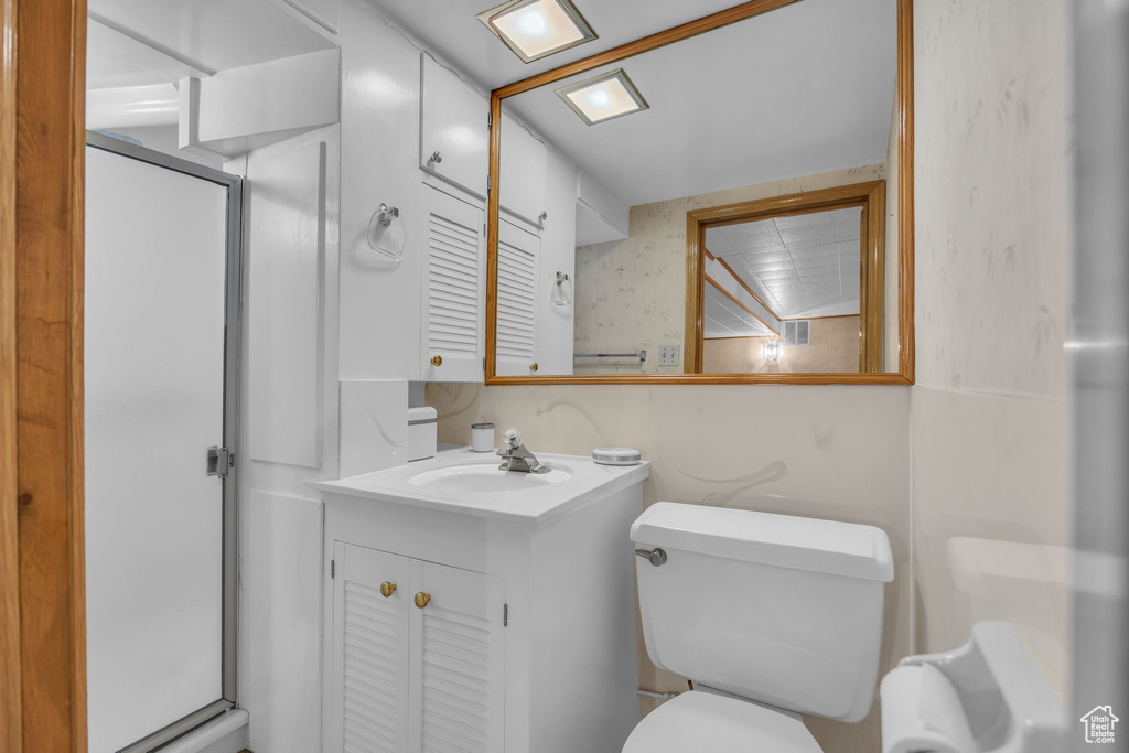 Bathroom with a stall shower and vanity