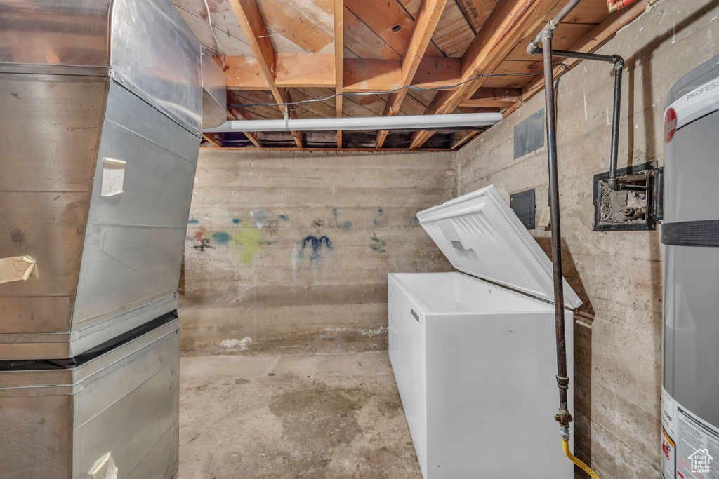 Unfinished below grade area featuring water heater