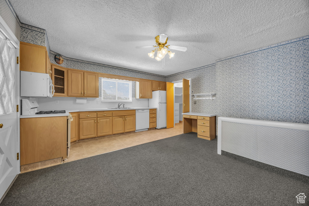 Kitchen featuring white appliances, ceiling fan, wallpapered walls, a textured ceiling, and light colored carpet