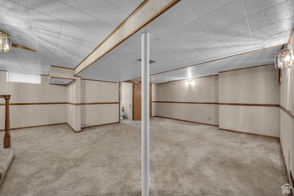 Below grade area featuring a paneled ceiling and carpet floors