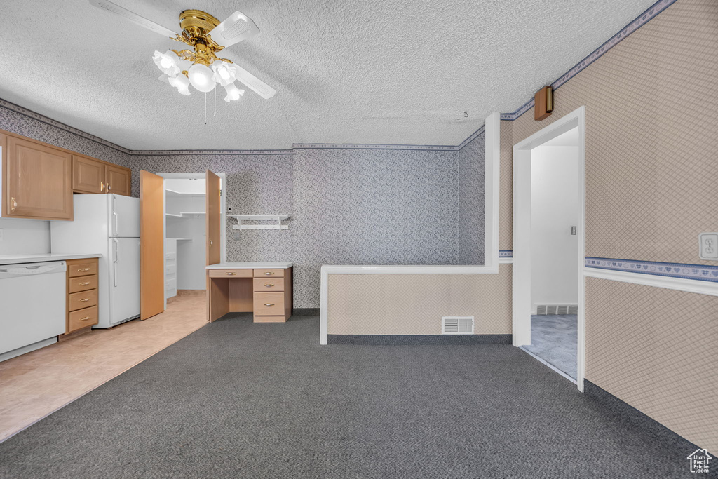 Miscellaneous room featuring a textured ceiling, a ceiling fan, light colored carpet, and wallpapered walls
