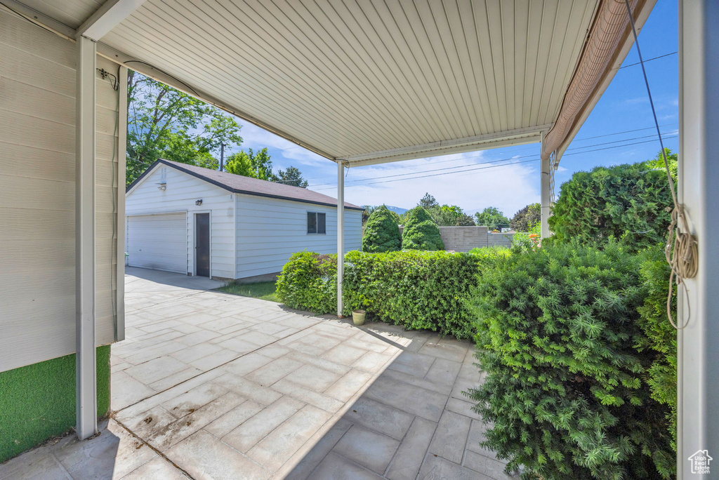 View of patio featuring an outbuilding