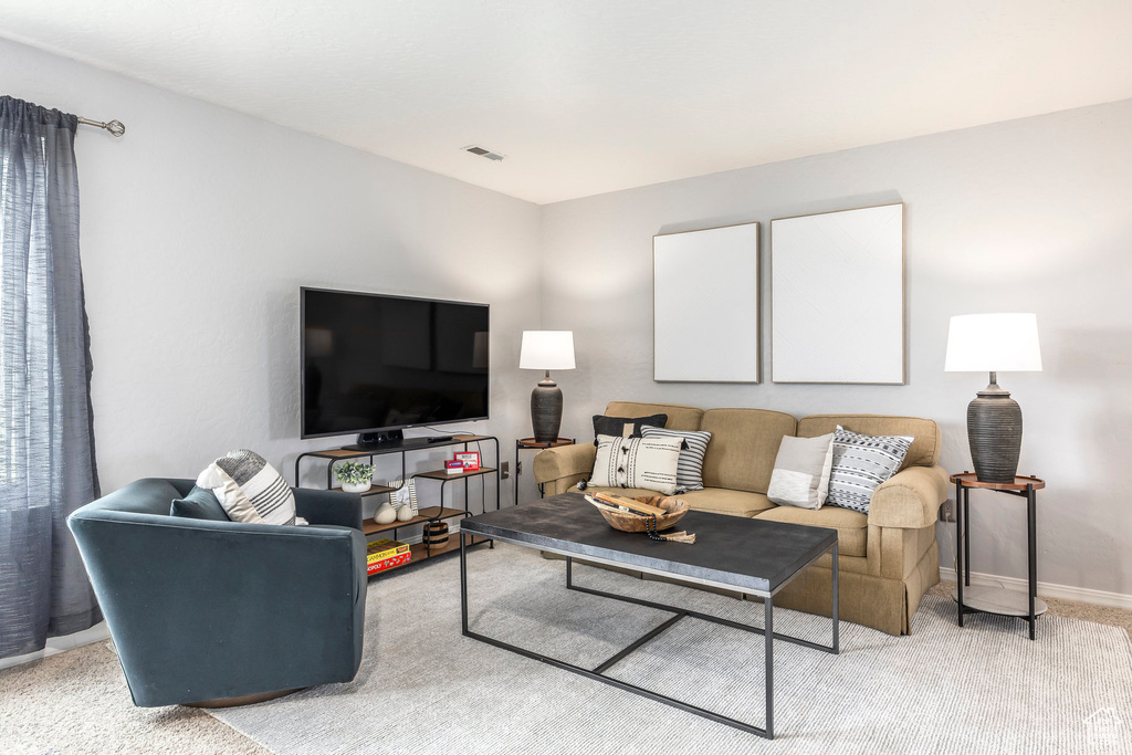 Living area with light carpet and baseboards