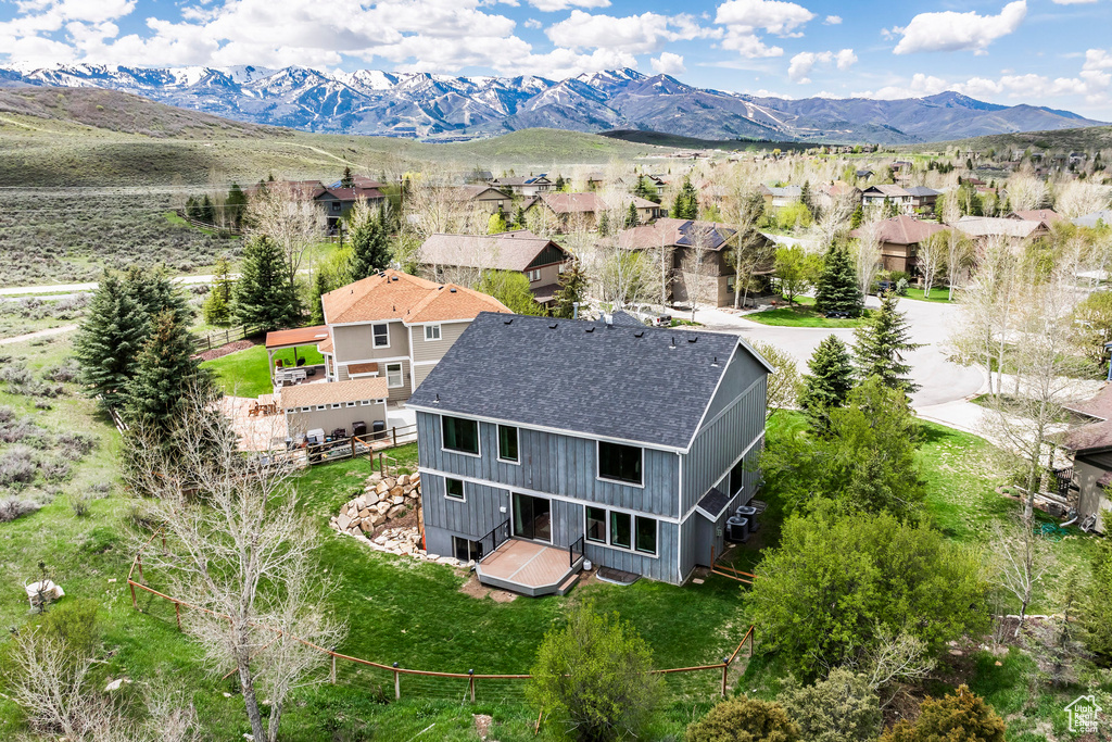 Aerial perspective of suburban area featuring a mountainous background