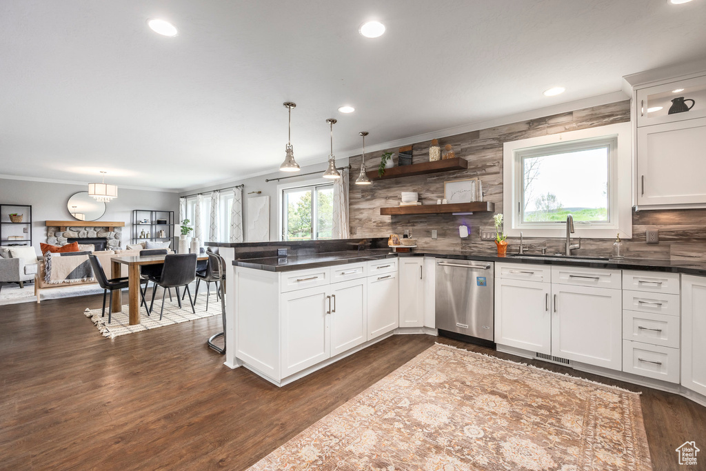 Kitchen featuring dishwasher, decorative backsplash, dark countertops, ornamental molding, and recessed lighting