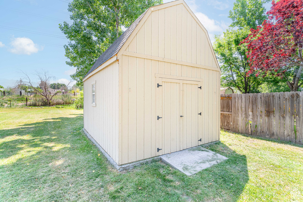 View of shed with a fenced backyard