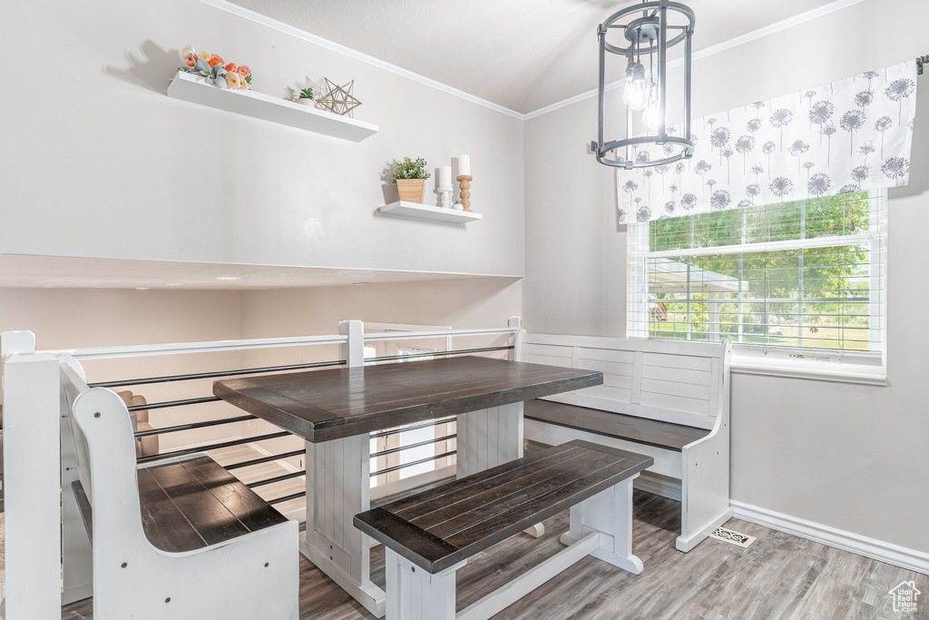Dining space featuring crown molding and wood finished floors