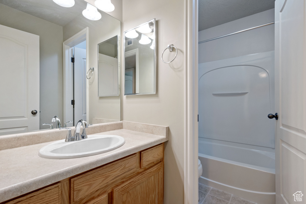 Full bathroom featuring vanity and shower / washtub combination