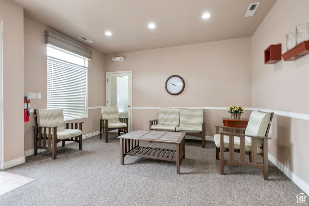 Carpeted living room featuring recessed lighting