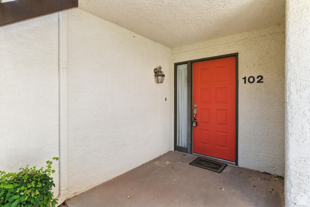 Property entrance with stucco siding