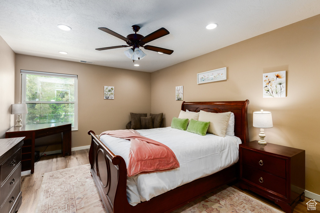 Bedroom featuring light wood-type flooring, recessed lighting, and ceiling fan