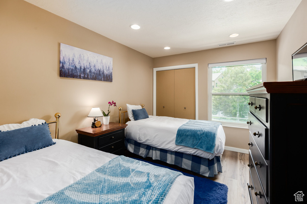 Bedroom with light wood-style flooring and recessed lighting