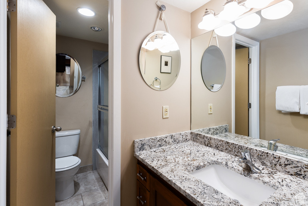 Bathroom with vanity, tile patterned floors, and bathtub / shower combination