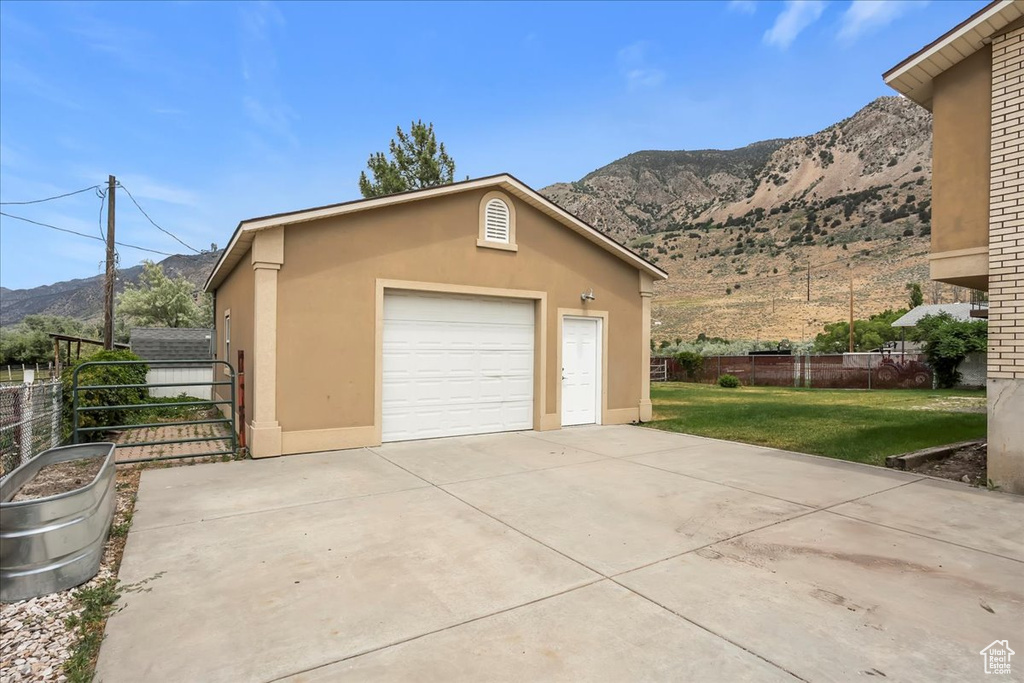 Detached garage with a mountain view and driveway