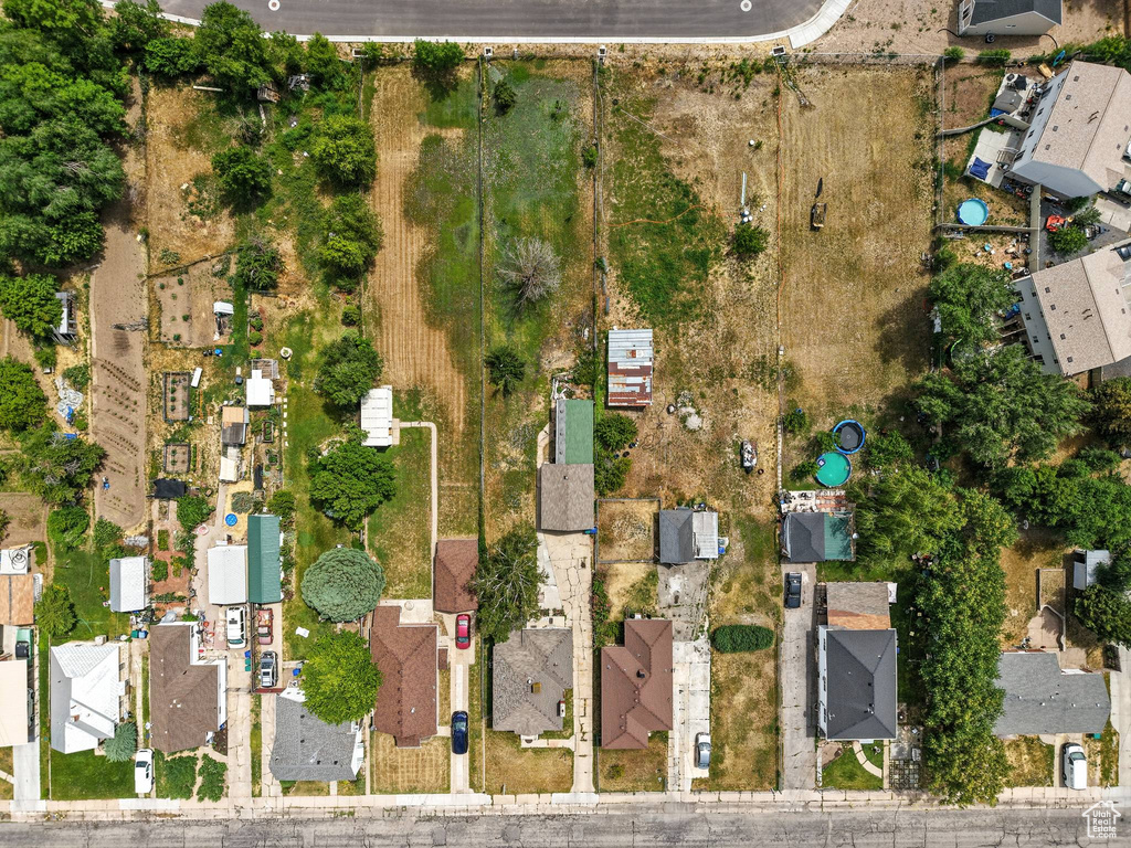 Aerial view of property and surrounding area with nearby suburban area