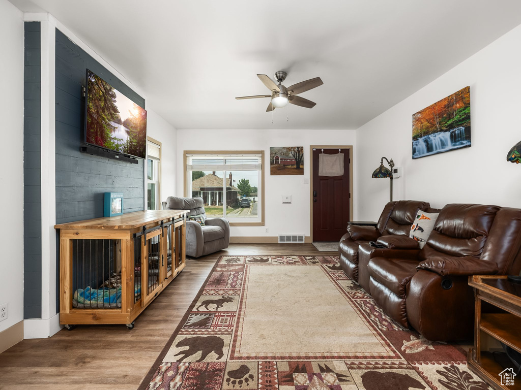 Living room featuring ceiling fan and wood finished floors