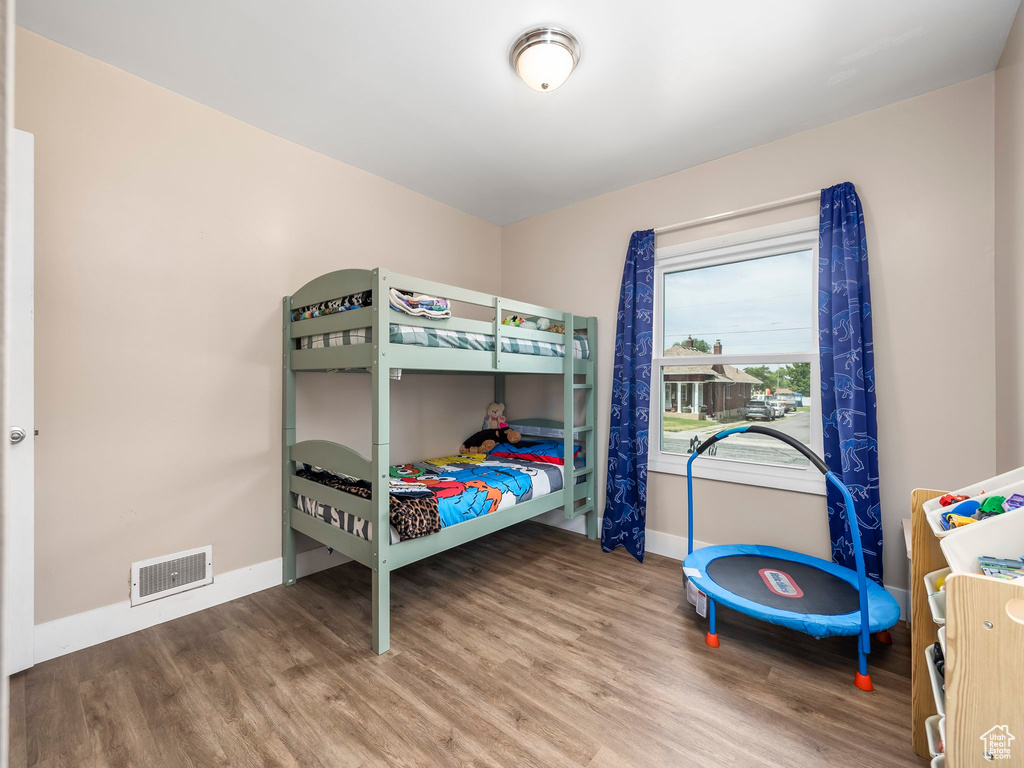 Bedroom featuring baseboards and wood finished floors