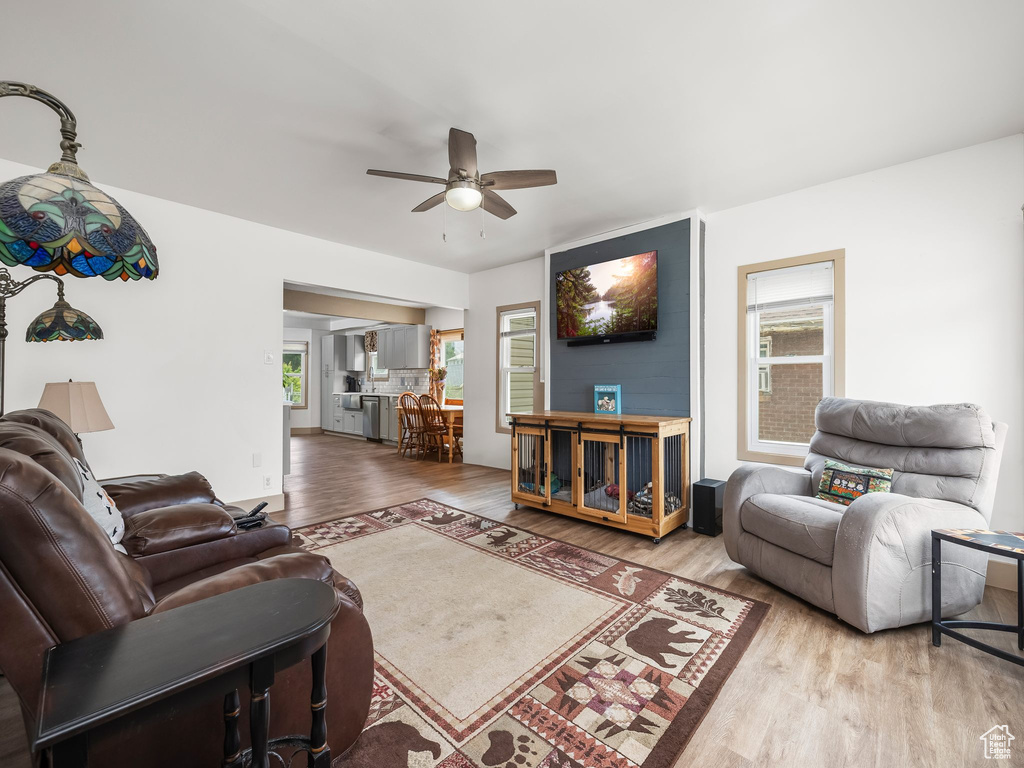 Living area with a ceiling fan and wood finished floors