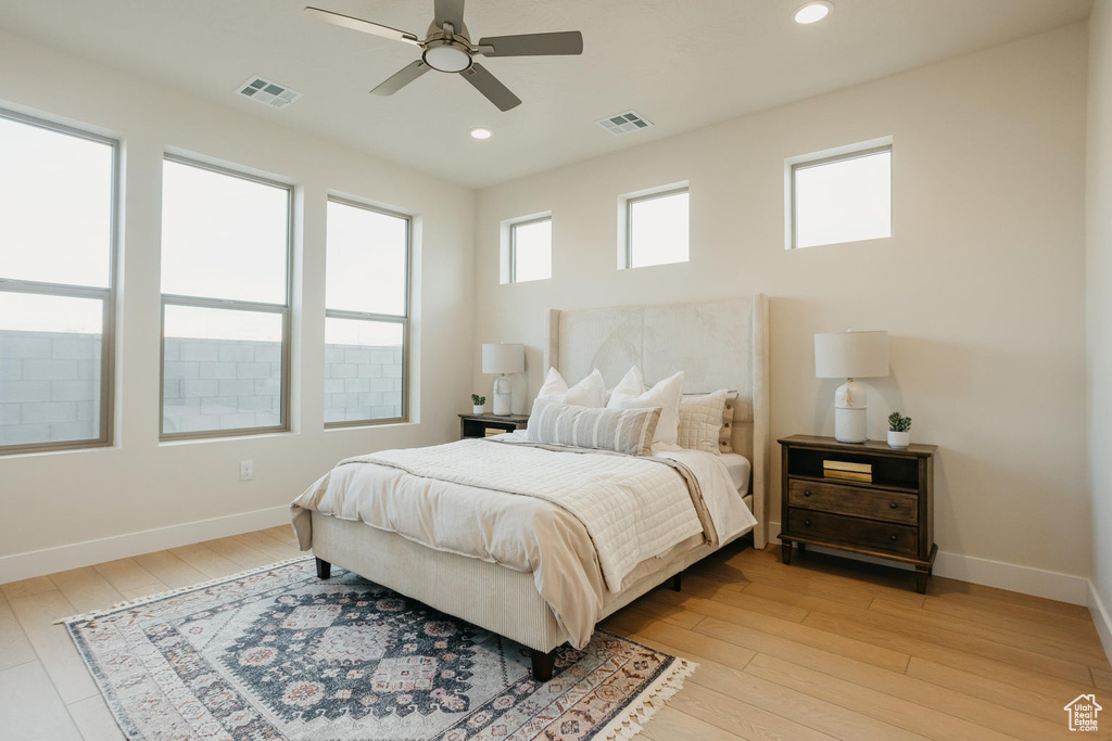 Bedroom with light wood-type flooring, recessed lighting, and ceiling fan
