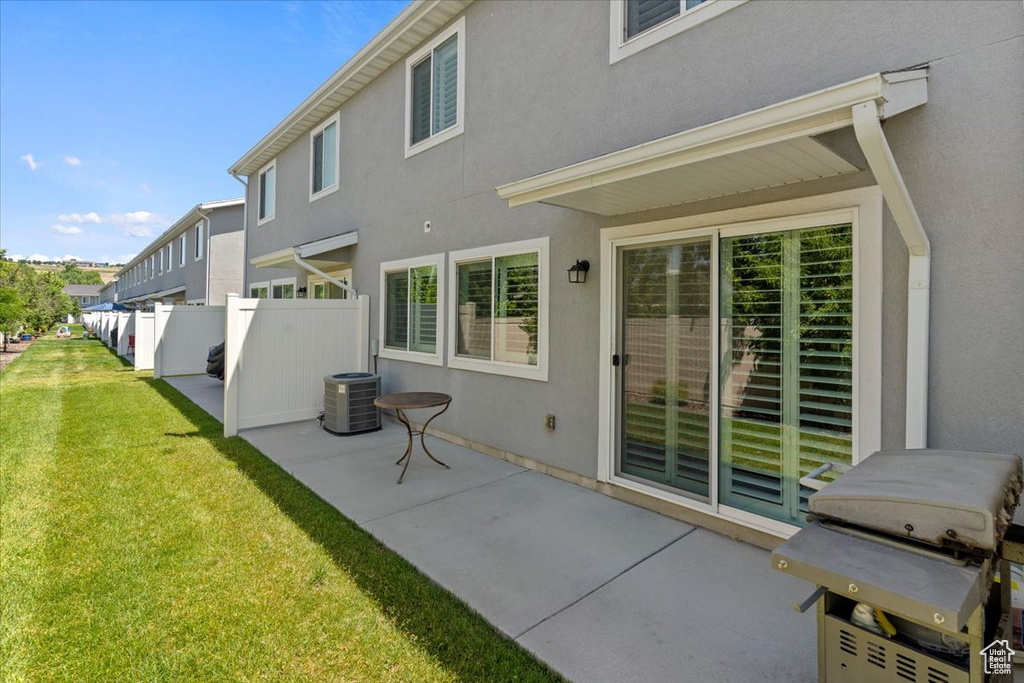 Back of property with a patio and stucco siding