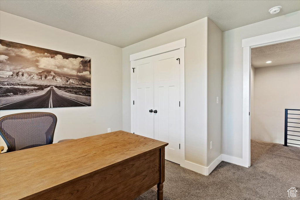 Carpeted office featuring baseboards
