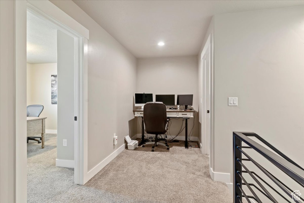 Carpeted office space with recessed lighting and baseboards