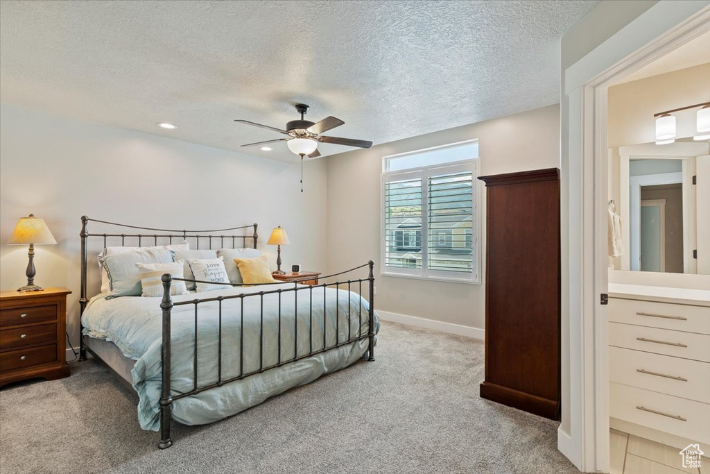 Carpeted bedroom featuring a textured ceiling, a ceiling fan, and recessed lighting