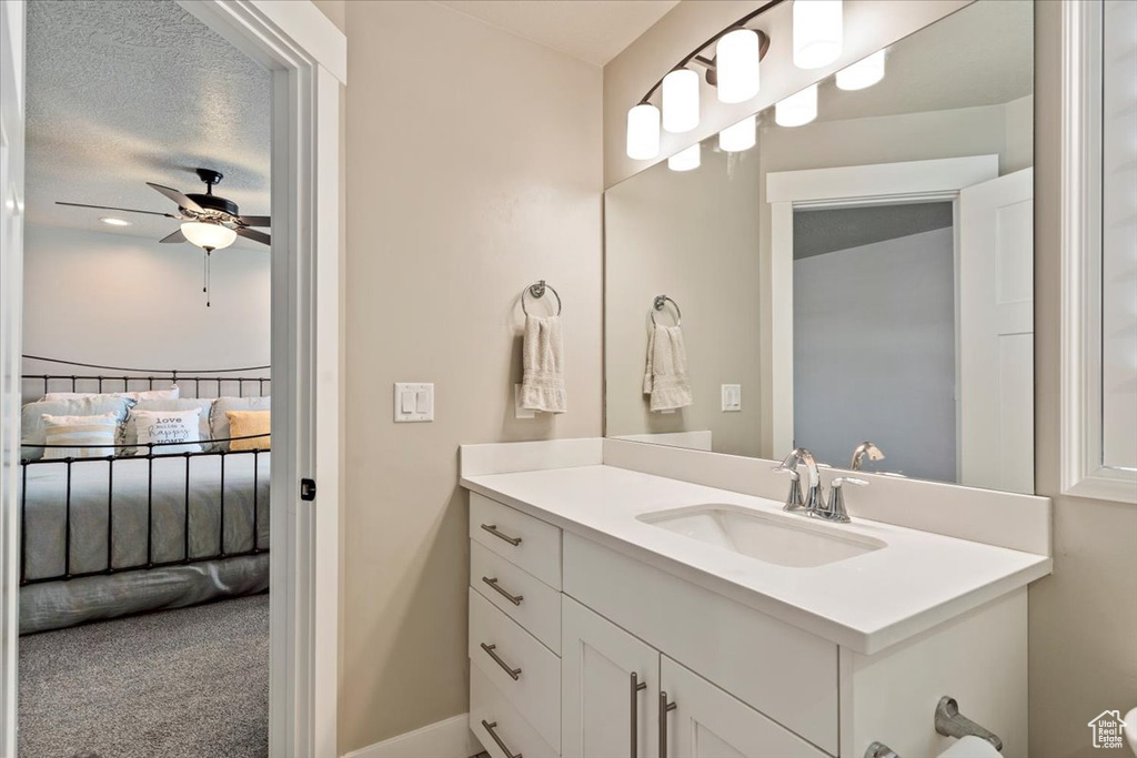 Bathroom featuring ensuite bathroom, vanity, and a ceiling fan