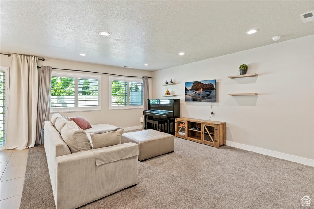 Living room featuring recessed lighting, a textured ceiling, and carpet floors