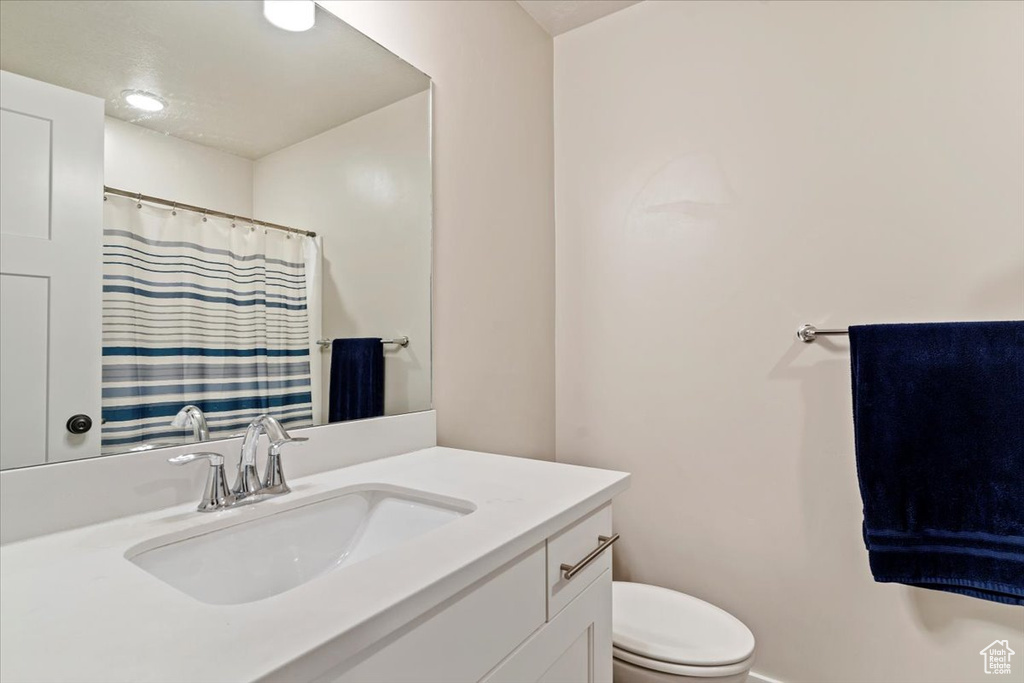 Bathroom featuring vanity and curtained shower